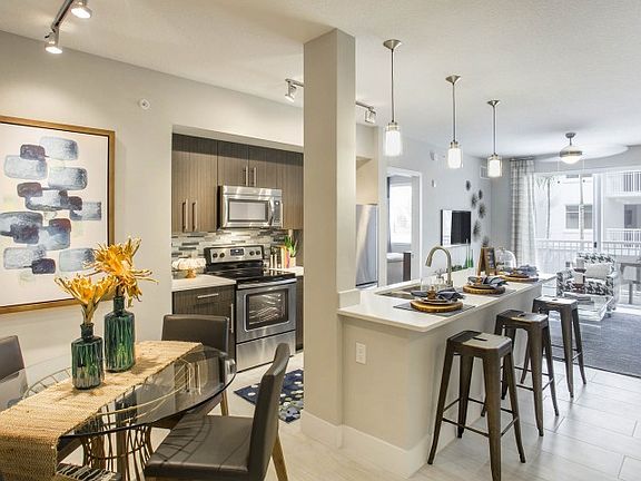 Kitchen and kitchen island within open concept apartment in Boca Raton.