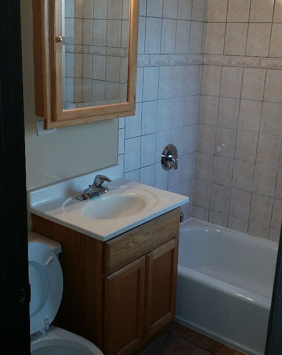 Bathroom with ceramic tile and wall tiles.