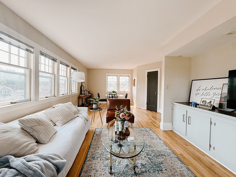 Living/dining area with built in storage cabinets/counter.