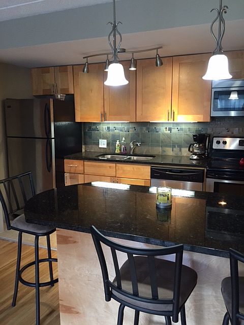 Kitchen with dishwasher and microwave.