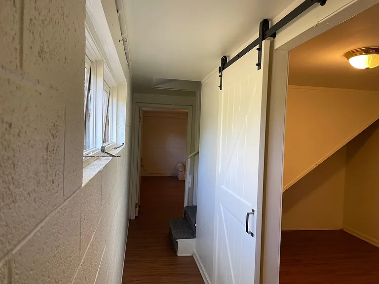 Looking down hallway w/ door to bedroom on right
