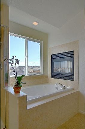 Jetted tub in update master bathroom with heated tile floors.