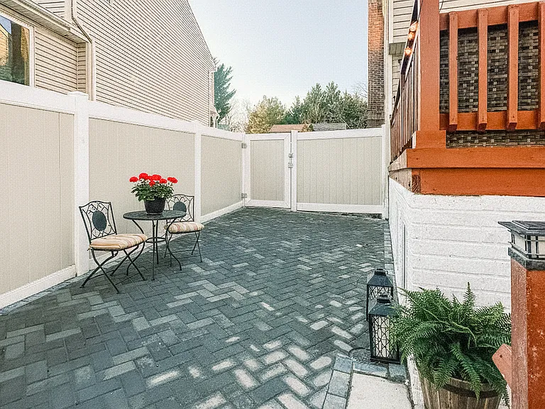 Private fenced backyard with patio space, outdoor seating, and room to relax.