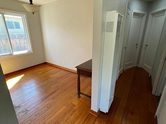Dining area and hallway to 2 main bedrooms; hardwood floors.