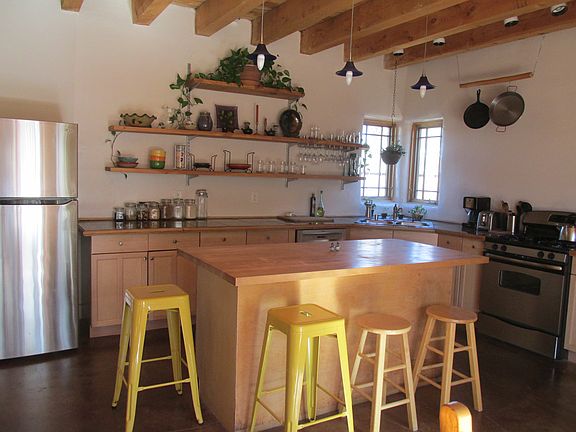 Kitchen island with stainless steel appliances, including ne