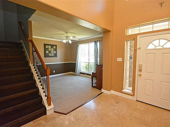 Travertine floors in a chiseled Versailles pattern with a beautiful staircase to greet you...you must see to appreciate the beauty.