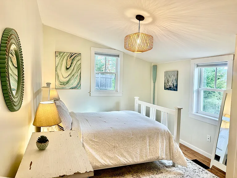 Cozy bedroom with peeking views of the water during late fall - early spring months.