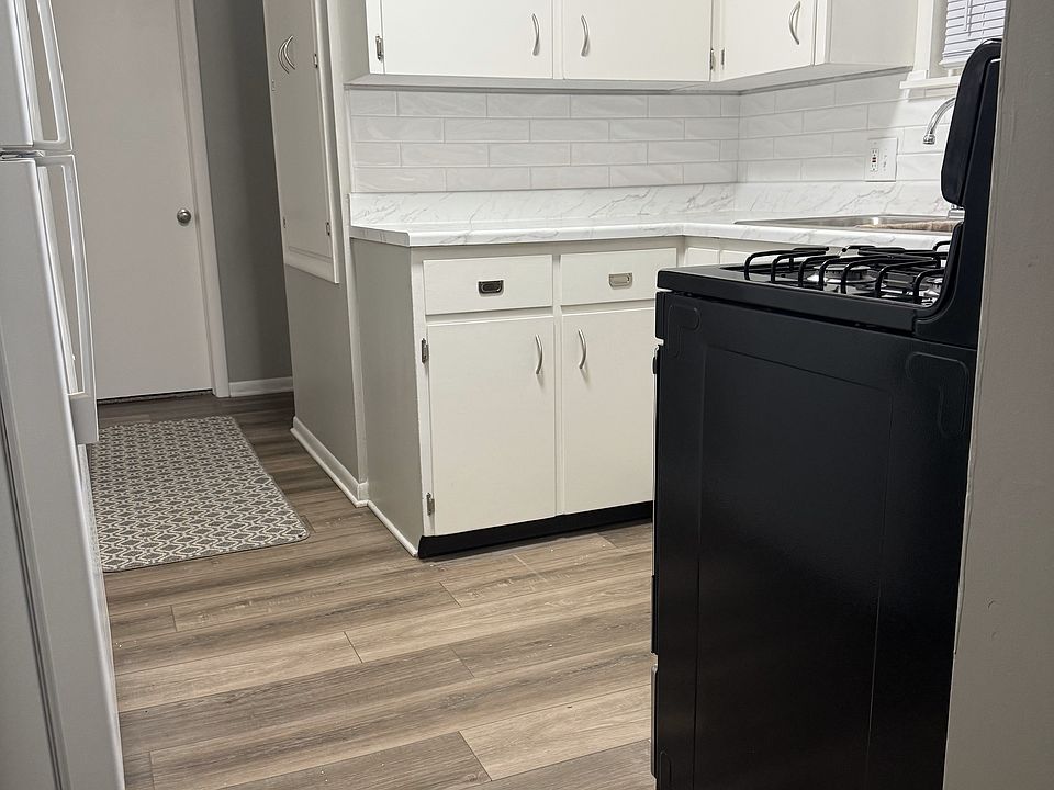 Kitchen hallway to 2 bedrooms, 2 hallway storage cabinets, full bath and stairs to basement.