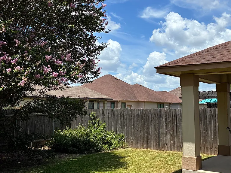 Large backyard with covered patio. (Patio furniture will 
stay with the house if requested.)