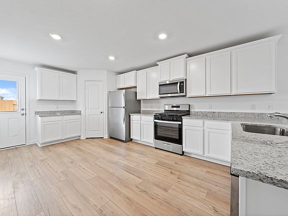 Whip up your favorite meals in the chef-ready kitchen with stainless steel appliances.