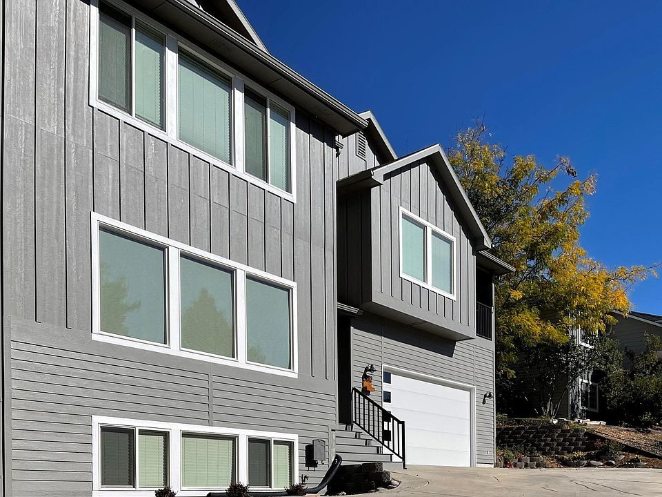 New board and batten siding, entry, garage door.