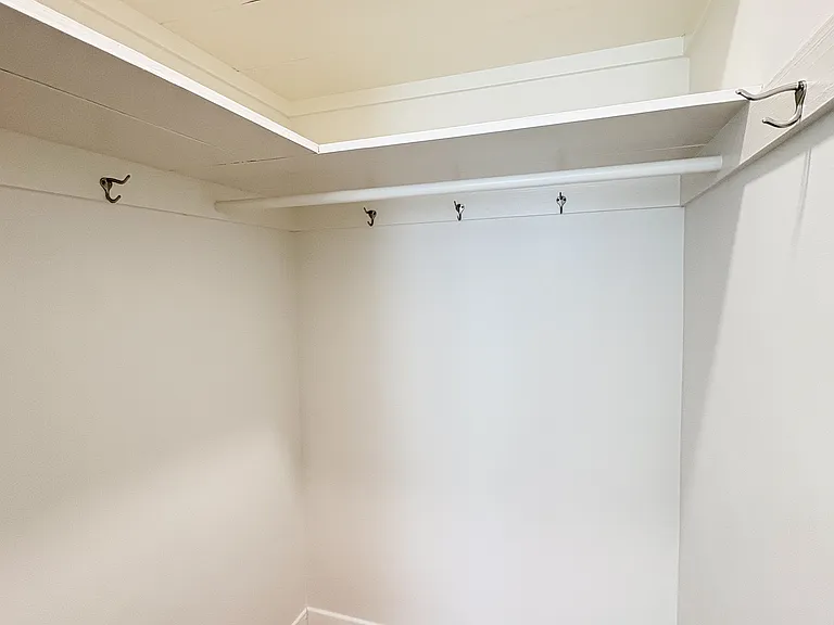 Primary bedroom walk-in closet