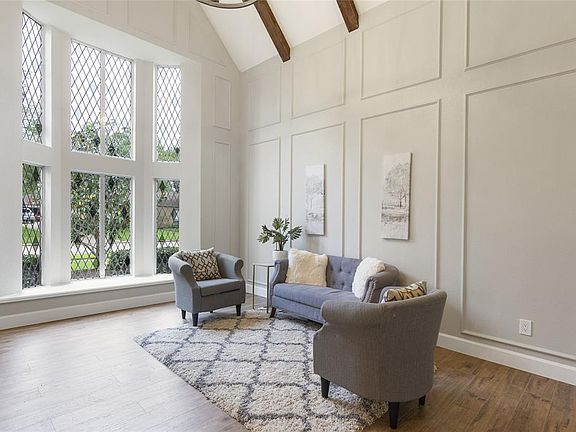 Formal living room with cathedral ceilings and beautiful beams