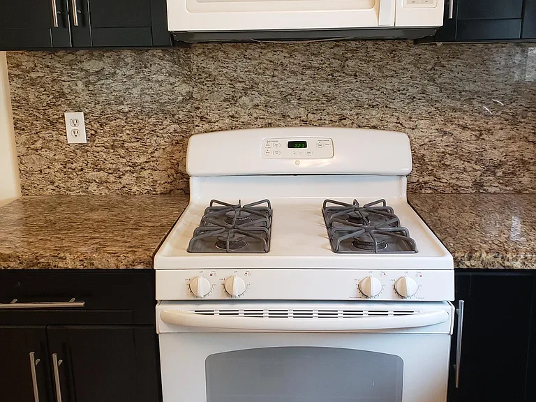 Stream clean gas oven with microwave and built in hood