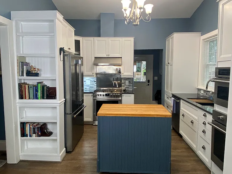 Full kitchen view from Keeping Room: Island rolls and can be turned in any direction desired or stored discreetly in the Laundry area when not in use. Note two wall ovens to the right: upper high end convection/microwave oven, lower electric oven.