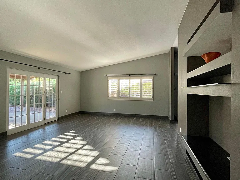 Living Room with vaulted ceiling, contemporary design elements, ample daylighting.