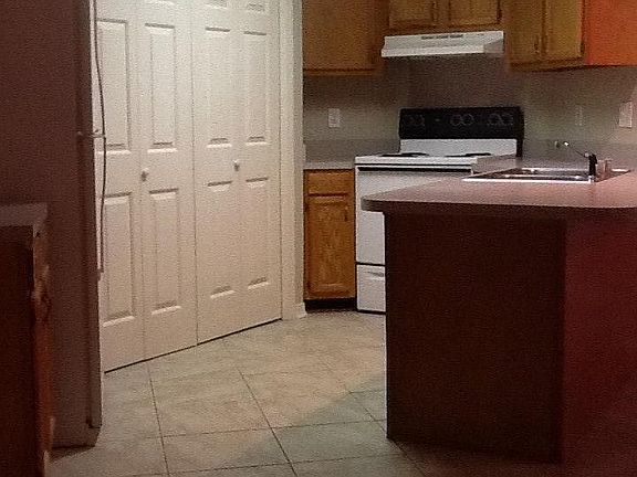 Kitchen with washer/dryer closet.