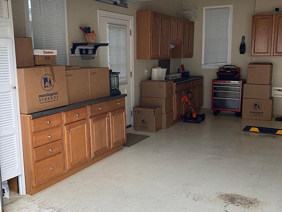 Garage has built in cabinets and counters