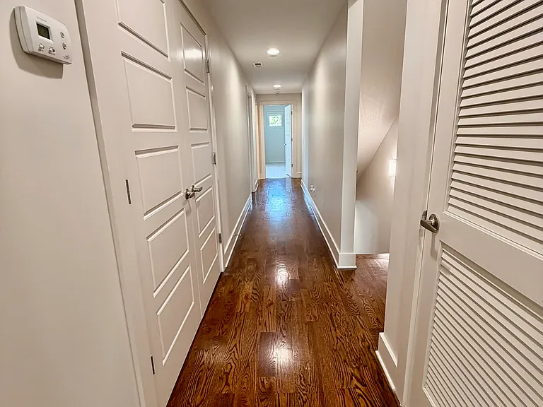 The second floor has three bedrooms and two full baths. Hardwood floors in the hallways.