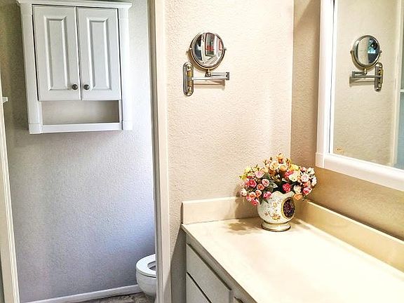 Bathroom with tub in master bedroom