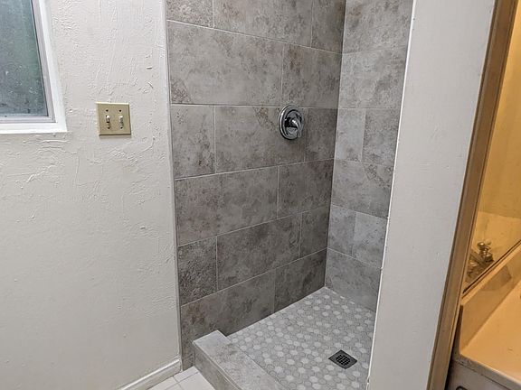 Upgraded bathroom shower with tile and a new toilet