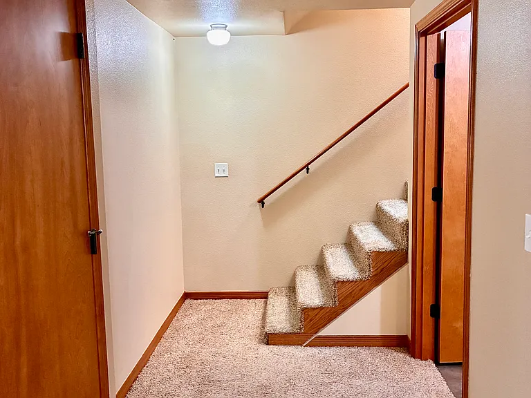 Stairs to living area and laundry area.