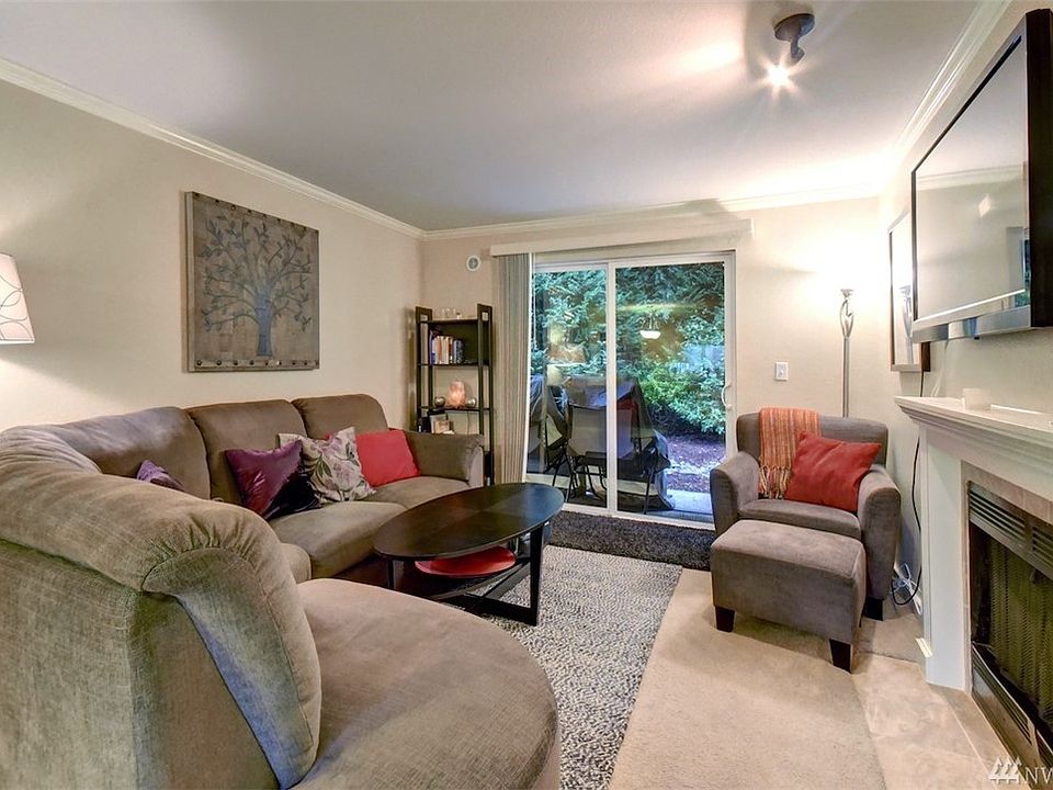 Cozy living room with crown moldiing overlooks a private green space.