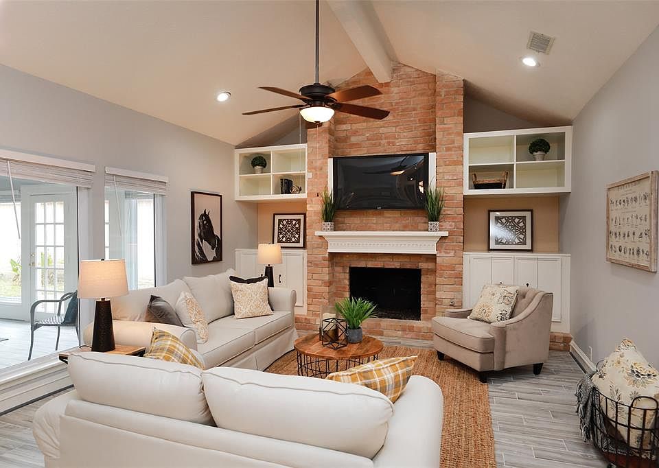 Light and bright living room with high ceilings, built-ins and gas fireplace.
