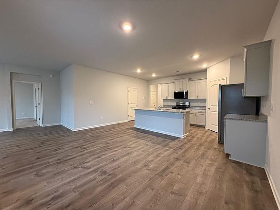 Granite Countertops, Stainless Steal Appliances and overview of breakfast area, living room and covered porch