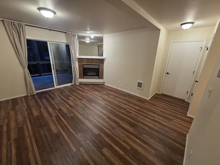Living area with sliding door to porch. Door goes to 1 car garage.