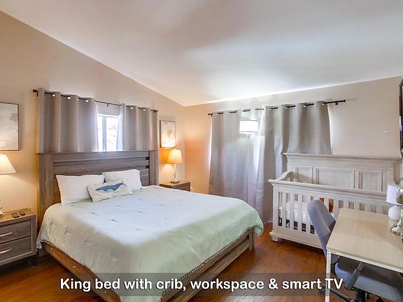Unwind and recharge in this cloud-like king bed, with a crib for your little ones