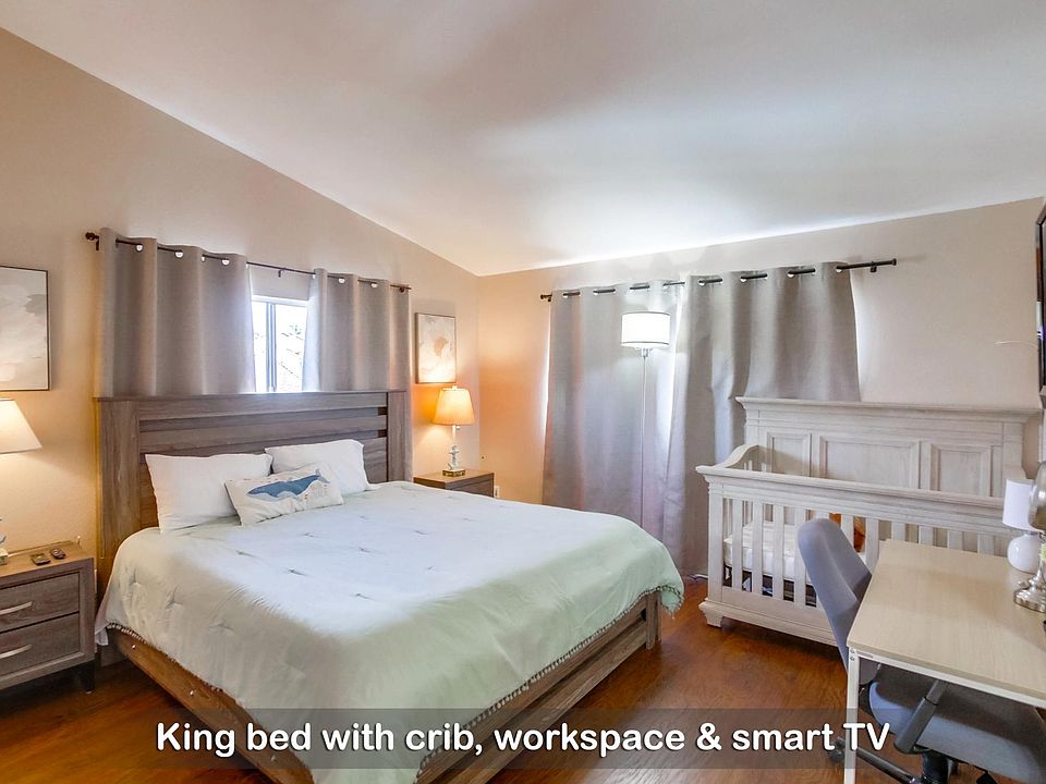 Unwind and recharge in this cloud-like king bed, with a crib for your little ones