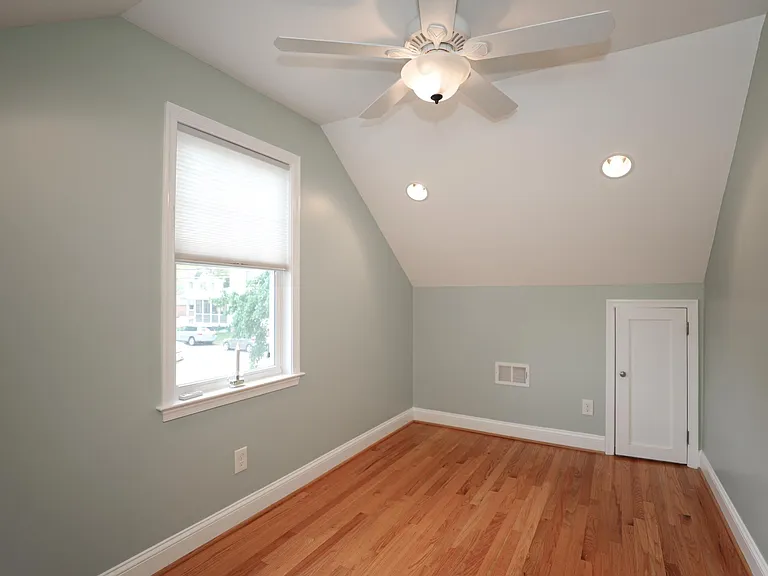 Spacious upper-level bedroom with vaulted ceiling.