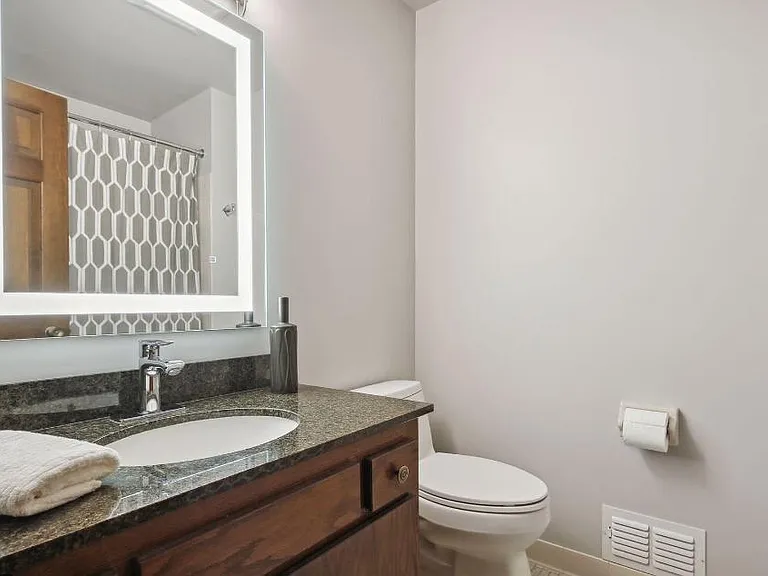 Another full bathroom with 3 light mirror