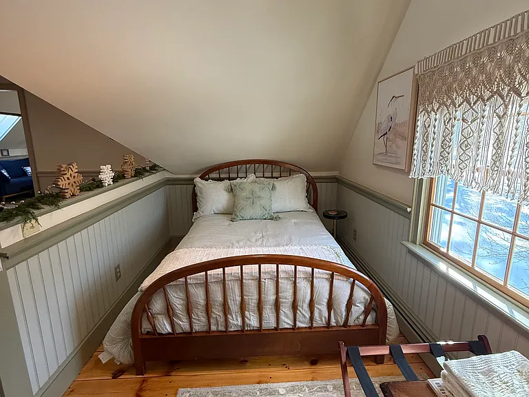 Full bed within the living room and office area