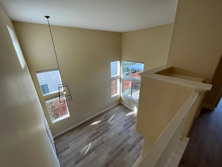 Living room with cathedral ceilings and plenty of windows
