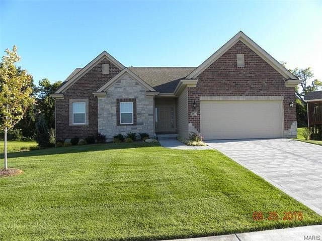Stately brick and stone front home with fully sodded yard, landscaping and irrigation system