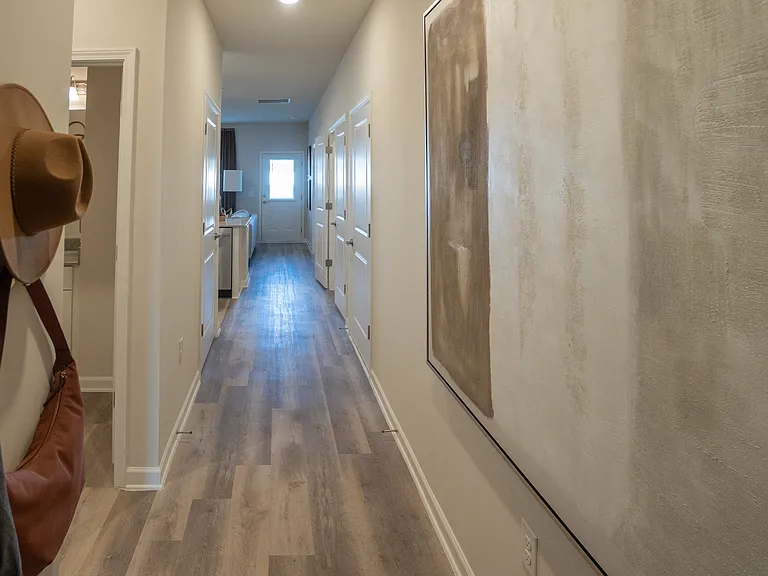 Entryway of the Richmond layout, with the front door behind you. Looking down the hallway into the living area.