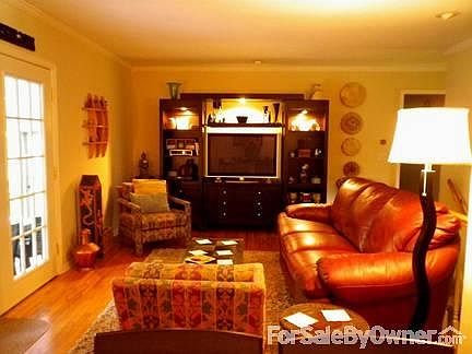 Cozy living room
						:
						Crown molding and French doors lead out to a screened porch.