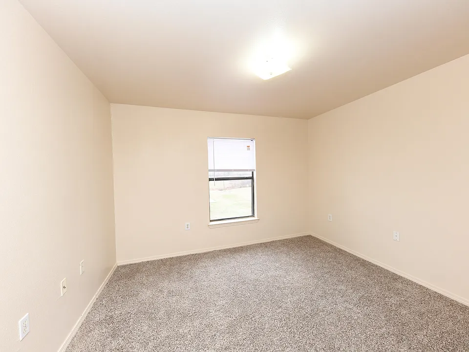 Cozy bedroom with carpet and overhead lighting