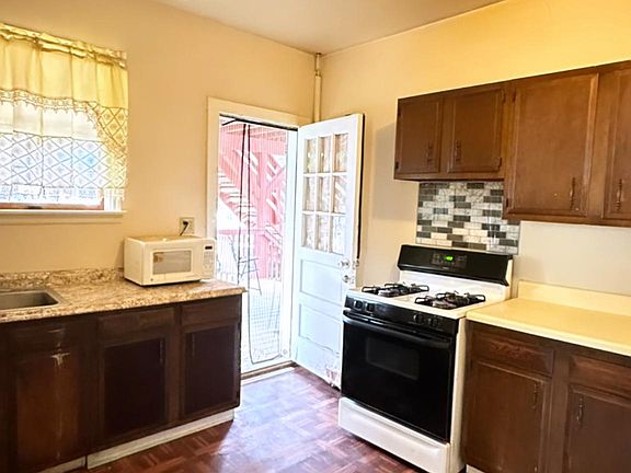 Kitchen - Photo 2 (door connects to ground patio and spacious backyard)