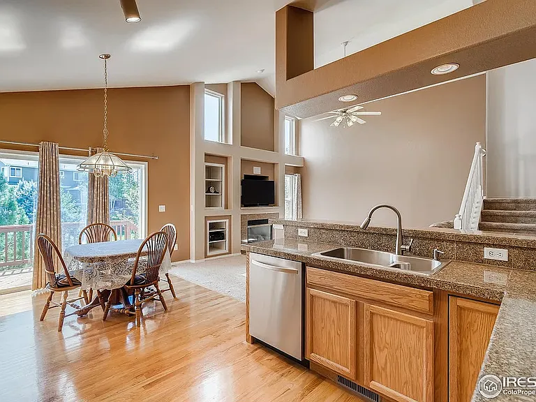 Kitchen into breakfast nook. Glass siding doors out to deck.