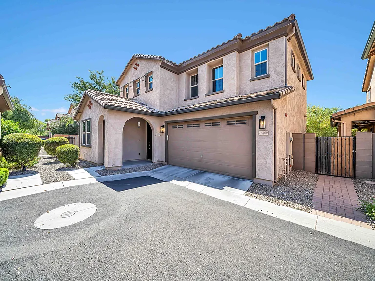 Exterior, 2 car garage with built in storage shelving and EV charger