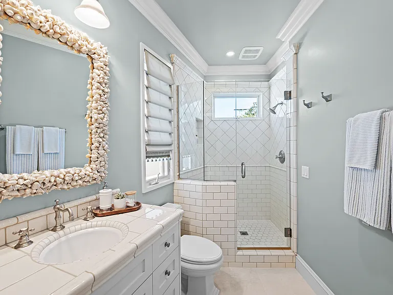 3rd bedroom bathroom with large shower, vanity with lots of storage.