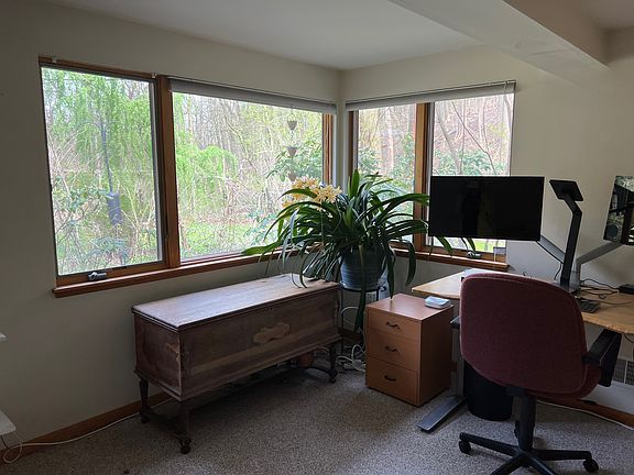 Another view of the bedroom with windows facing backyard and Frick Park.