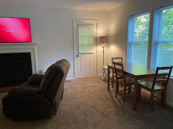 Main level extra table/chairs and exit door to Deck.
