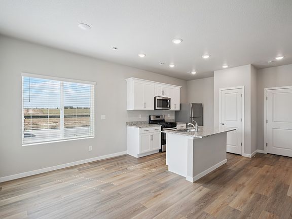 The kitchen is located next to the dining room.