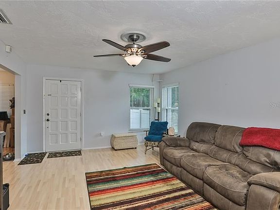 Notice the nice updated flooring throughout this open floor plan; view looking back at front door