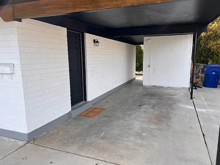 Carport space and door to apartment