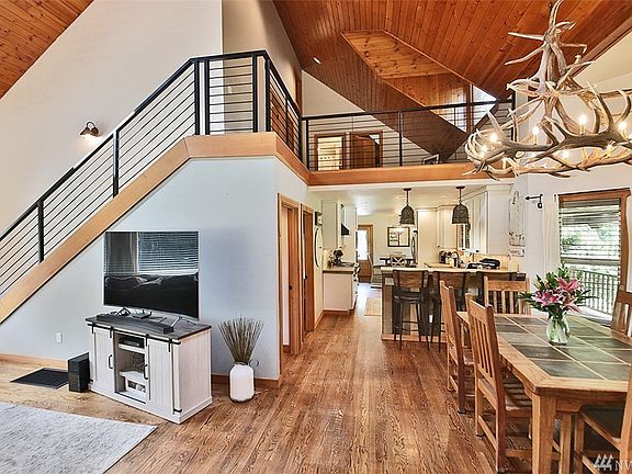 From Front door looking to dining, kitchen, breakfast nook. Living room to left and beautiful custom handrail constructed by local artisan.